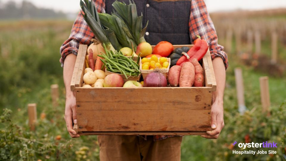 Farmer carrying a box of fresh vegetables