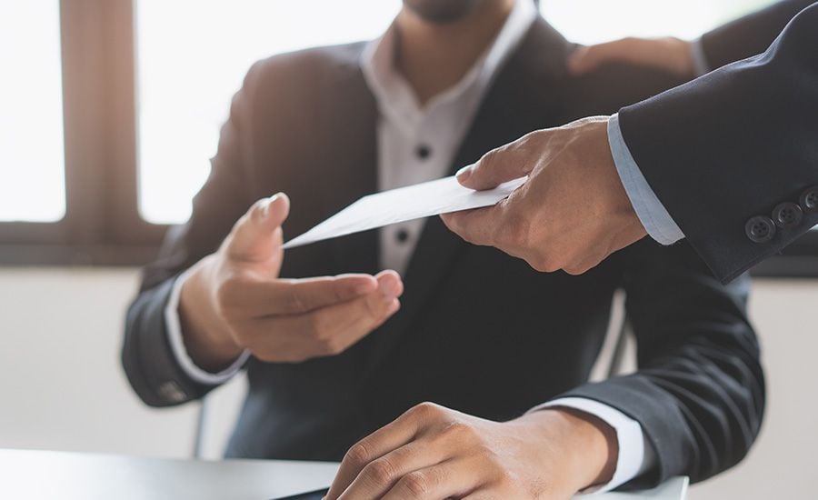 An employee receiving a paycheck from his employer.