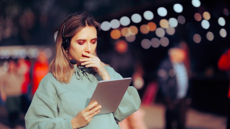 female event manager looking at her tablet