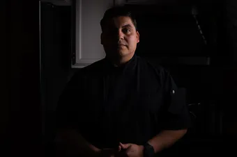 Chef Ismael Torres fixing a lamp on the table
