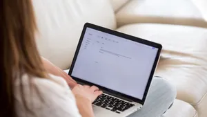 Woman writing a cover letter on her laptop