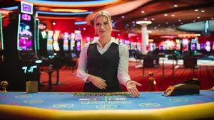 Female gambling dealer with her hand on the casino table