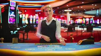 Female gambling dealer with her hand on the casino table