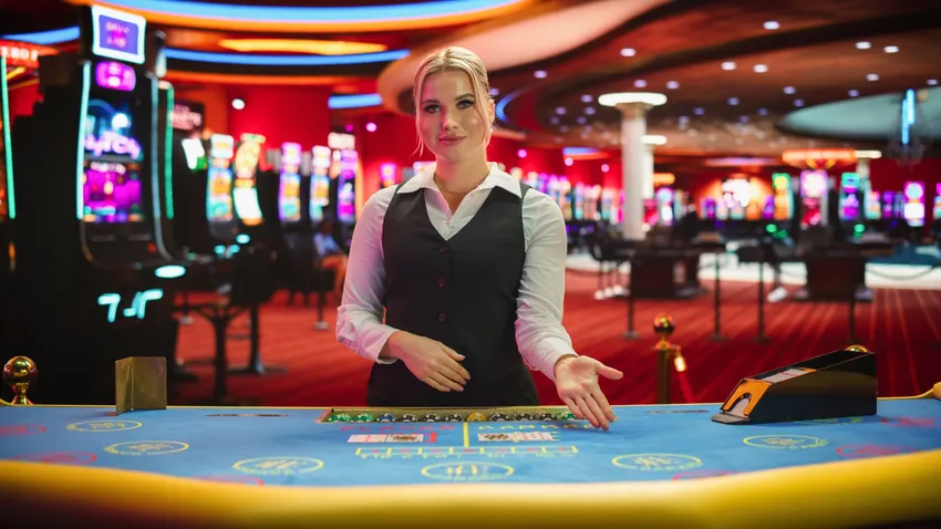 Female gambling dealer with her hand on the casino table