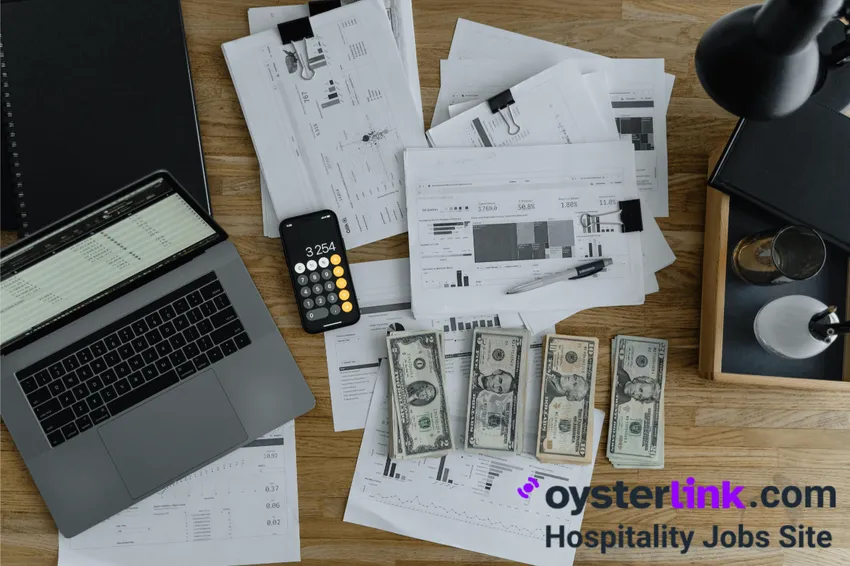 desk with money calculator laptop and documents