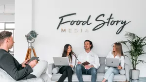 Nathan Sno, Founder of Food Story Media, with others holding laptops and talking