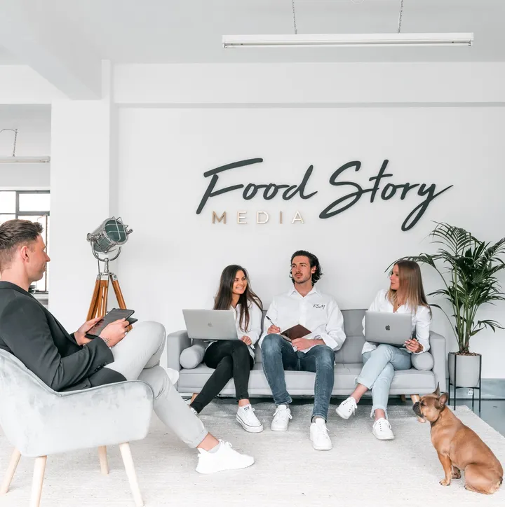 Nathan Sno, Founder of Food Story Media, with others holding laptops and talking