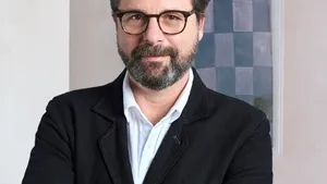 David Hellbronn standing, wearing a black suit