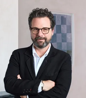 David Hellbronn standing, wearing a black suit