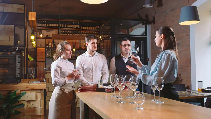 bar manager explaining glassware
