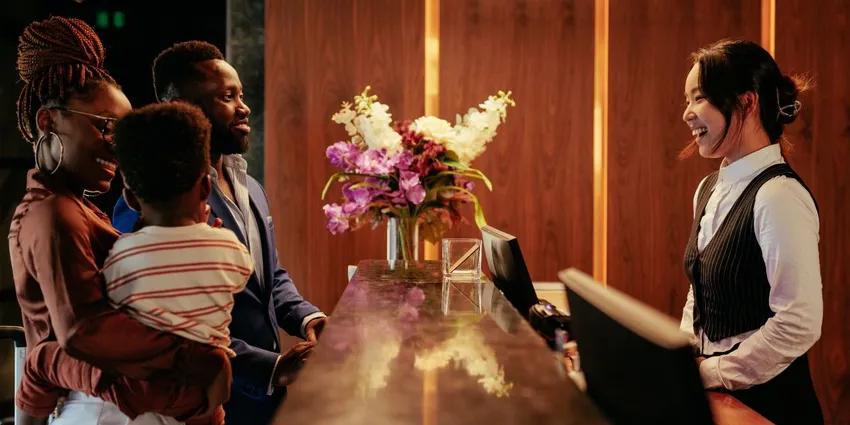 Asian female concierge helping a female guest with her registration