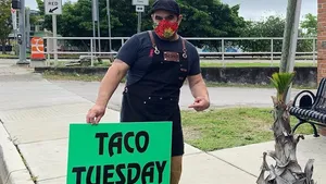 Jodrick Ujaque holding a roasted chicken