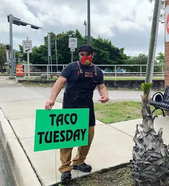 Jodrick Ujaque holding a roasted chicken