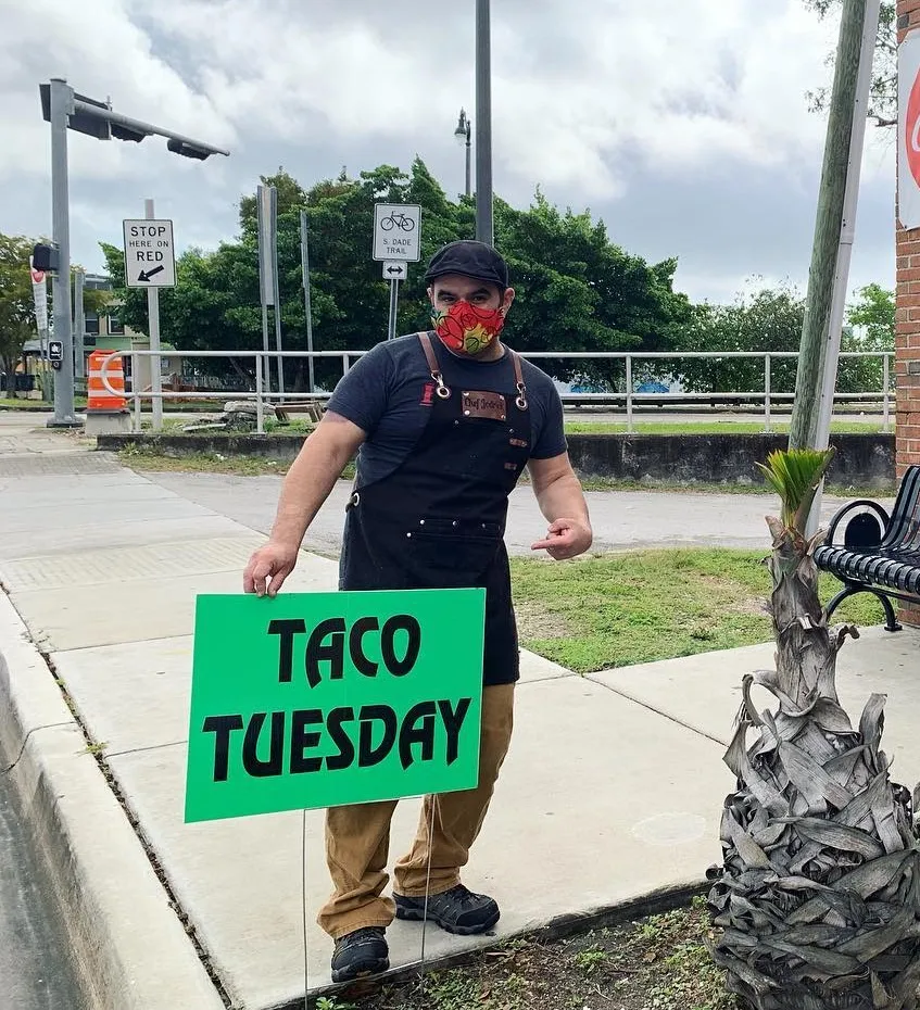 Jodrick Ujaque holding a roasted chicken