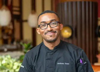 Chef Anthony Jones working at the kitchen cutting vegetables