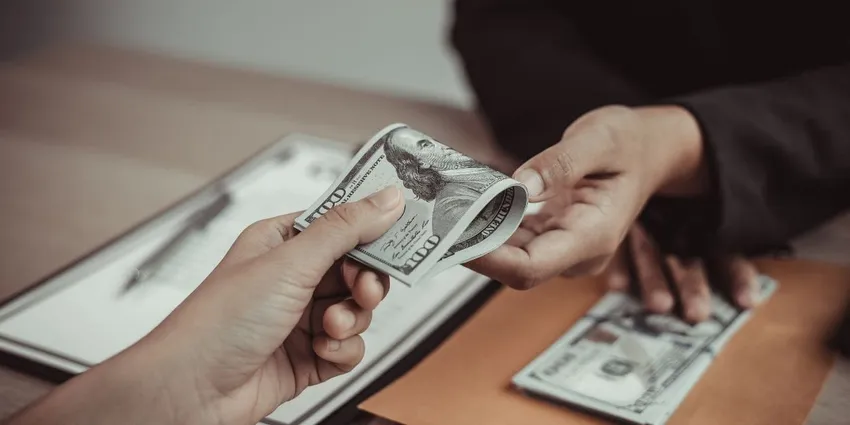 Handing out 100 dollar bill