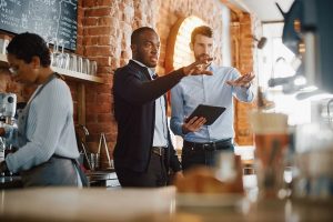 A restaurant manager discusses the table arrangements in a restaurant