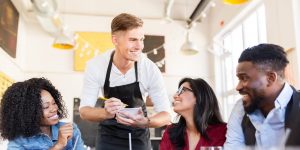 A male Server taking customers' orders