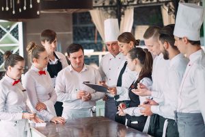 A restaurant manager discusses the daily tasks with her team