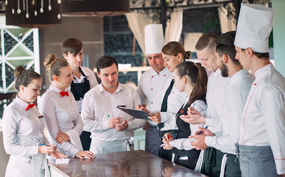 A restaurant manager discusses the daily tasks with her team