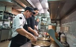 Cooks working in restaurant kitchen