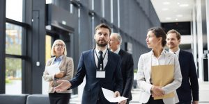 An Event Planner talking to the planning team while walking along the hallway