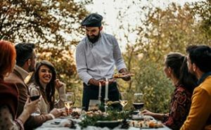 a private chef serving dinner to their clients