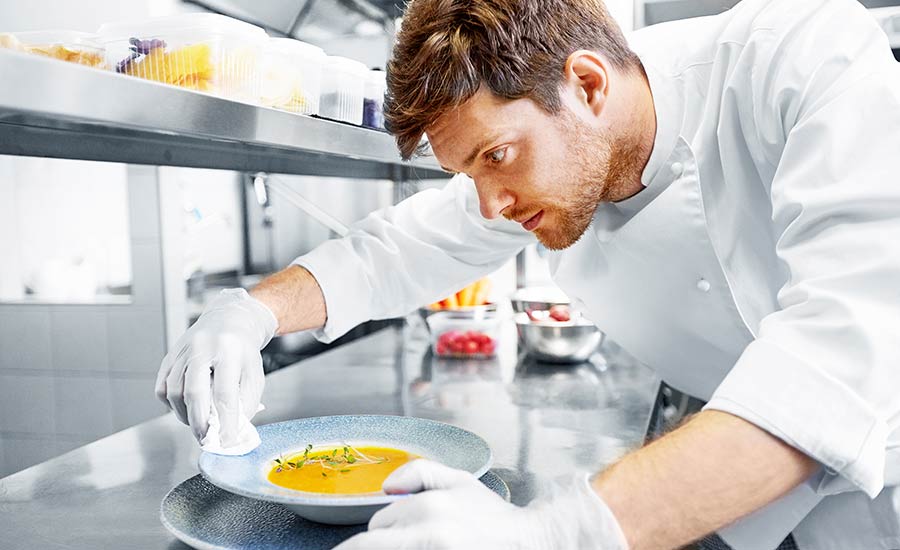 A Miami cook making the last plating adjustments