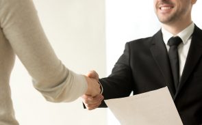 A job candidate shaking an employer's hand