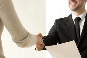 A job candidate shaking an employer's hand