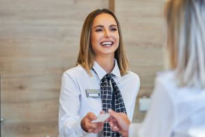 A female Hotel Front Desk Agent talking to a female guest