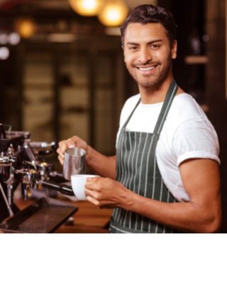 A barista about to pour coffee into a cup