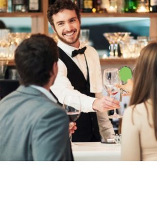 A bartender at the bar serving drinks