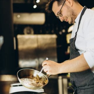 A cook preparing a dish