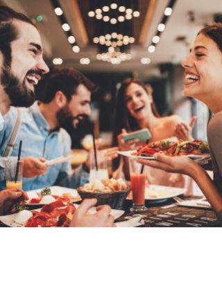 Group enjoying a meal together at a table