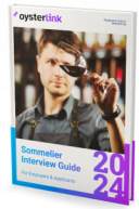 A sommelier looking at a wine glass