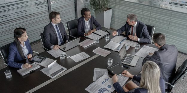 A group of executives having a meeting in the offce