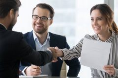 A female employee shaking hands with a recruiter