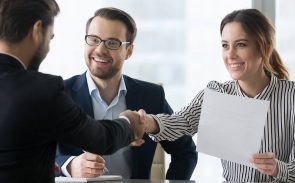 A female employee shaking hands with a recruiter