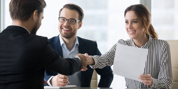 A female employee shaking hands with a recruiter