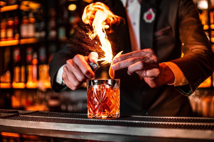 bartender garnishing cocktail