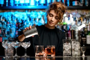 young bartender behind a bar