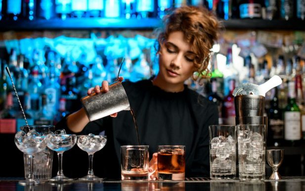 young bartender behind a bar