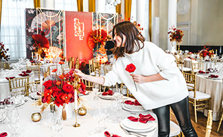 event coordinator decorating a table at an event