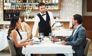 fine dining server in a restaurant with customers