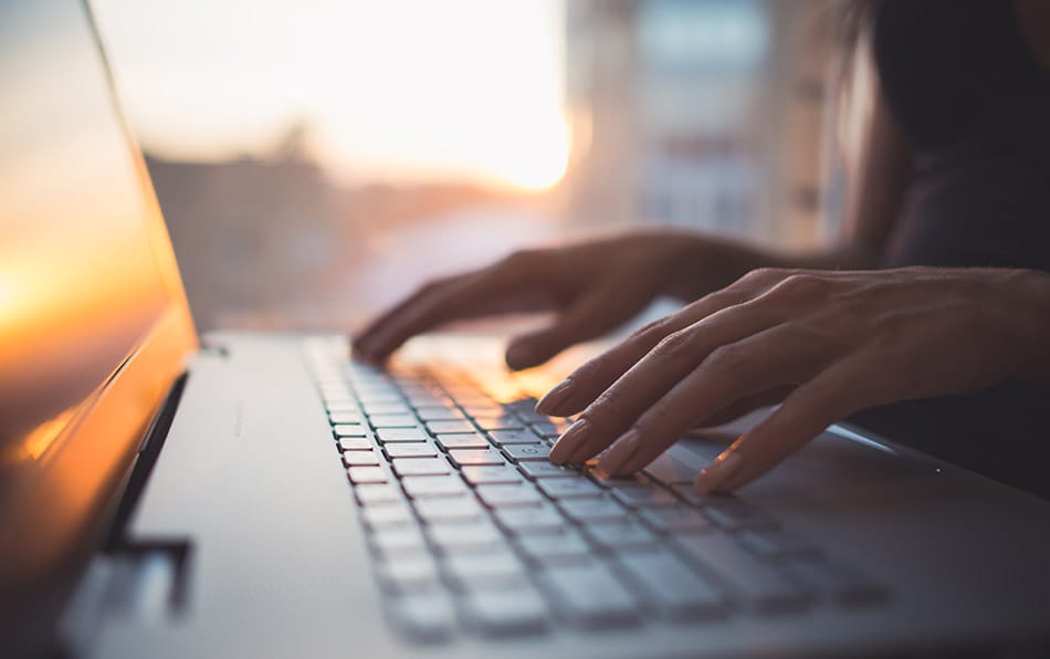 person typing on laptop