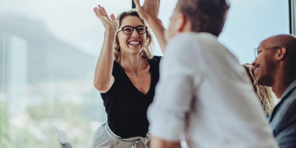 A female leader high fiving a team member