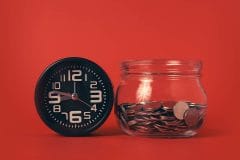 A clock and a tip jar with a red background