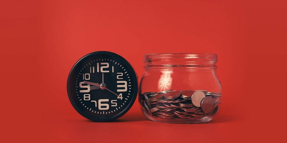 A clock and a tip jar with a red background