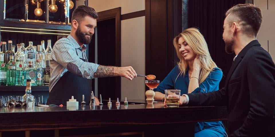 bartender serving customers with a smile